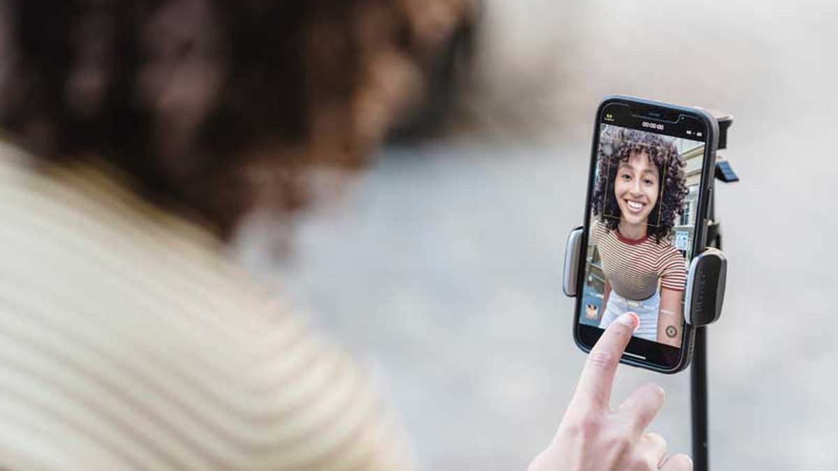 Creator filming a vertical TikTok video on a phone tripod