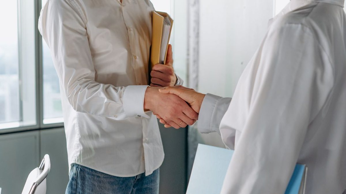 Two businessmen shaking hands over a sponsorship deal